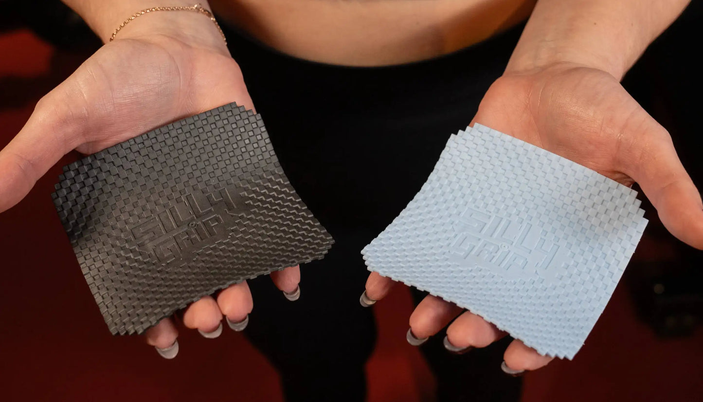 Two hands wearing textured black and blue grip pads for weightlifting