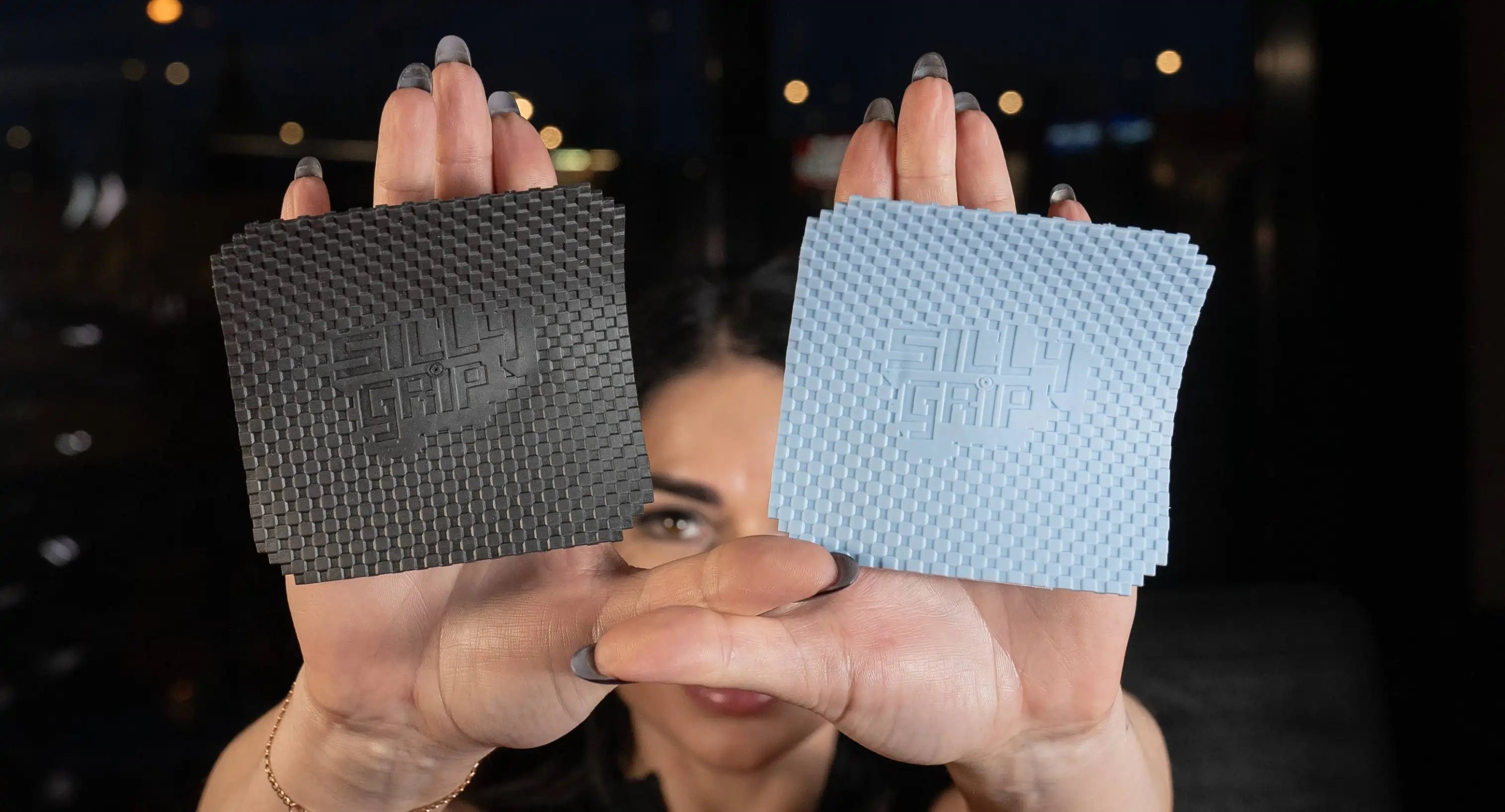 grey and blue sillygrip weightlifting pads display by a women on her palms
